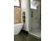 Elegant bathroom with a freestanding tub, shower with glass doors, and a tiled wall with a niche at 3 Carriage Brook Rd, Cherry Hills Village, CO 80121