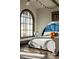 Bright bedroom features a large window, a unique headboard, and stylish décor elements at 3 Carriage Brook Rd, Cherry Hills Village, CO 80121