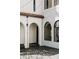 Bright courtyard featuring white stucco, arched openings, and decorative string lights at 3 Carriage Brook Rd, Cherry Hills Village, CO 80121