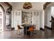 Cozy dining space with built-in cabinets, unique chandelier and four chairs around round table at 3 Carriage Brook Rd, Cherry Hills Village, CO 80121