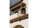 Architectural details showcase the wood beam supported overhang, the curved windows, and red tile roof at 3 Carriage Brook Rd, Cherry Hills Village, CO 80121