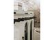 Exterior architectural detail featuring white stucco, arched windows, and decorative beams at 3 Carriage Brook Rd, Cherry Hills Village, CO 80121