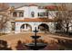 Stunning two-story home features a beautiful red tile roof and a grand fountain in front at 3 Carriage Brook Rd, Cherry Hills Village, CO 80121