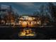 Exterior view of stunning home at twilight featuring illuminated fountain and lush surrounding landscape at 3 Carriage Brook Rd, Cherry Hills Village, CO 80121