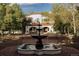 Stunning front yard with a classic fountain and grand Spanish-style home featuring a red tile roof at 3 Carriage Brook Rd, Cherry Hills Village, CO 80121
