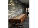 Spacious game room with a striking mural and classic wood shuffleboard table at 3 Carriage Brook Rd, Cherry Hills Village, CO 80121