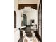 Elegant hallway leading to other rooms, highlighting the architecture, including arched doorways and dark wood floors at 3 Carriage Brook Rd, Cherry Hills Village, CO 80121