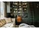 Stylish home office features custom shelving, a leather desk chair, and natural light from large windows at 3 Carriage Brook Rd, Cherry Hills Village, CO 80121