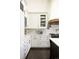 Charming kitchen with white cabinets, marble countertops, and stainless steel appliances at 3 Carriage Brook Rd, Cherry Hills Village, CO 80121