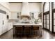 Well-appointed kitchen with a large island, breakfast bar, and high-end appliances at 3 Carriage Brook Rd, Cherry Hills Village, CO 80121