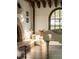 Bright living room boasts a fireplace, grand piano, and arch window with window seat at 3 Carriage Brook Rd, Cherry Hills Village, CO 80121