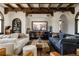 Spacious living room with wood beam ceiling, stylish furnishings, and a large entertainment center at 3 Carriage Brook Rd, Cherry Hills Village, CO 80121