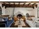 Spacious living room with wood-beamed ceiling, fireplace, comfortable seating, and rustic wooden coffee table at 3 Carriage Brook Rd, Cherry Hills Village, CO 80121