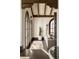 Elegant living room features exposed beams, arched windows, hardwood floors, and comfortable seating at 3 Carriage Brook Rd, Cherry Hills Village, CO 80121