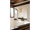 Loft area with a large window, dark wood beams, and a decorative light fixture at 3 Carriage Brook Rd, Cherry Hills Village, CO 80121