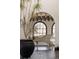 Elegant sitting area with a white piano, built-in window seat, and decorative arches at 3 Carriage Brook Rd, Cherry Hills Village, CO 80121