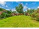 A well-maintained backyard with a covered patio and lush green lawn at 3049 S Williams St, Denver, CO 80210
