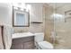 Modern bathroom featuring tiled shower with glass door, contemporary fixtures, and vanity storage at 3049 S Williams St, Denver, CO 80210
