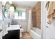 Bathroom features modern fixtures, a shower-tub combo, and vanity storage at 3049 S Williams St, Denver, CO 80210