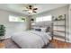 Well-lit bedroom with a comfortable bed, decorative shelves, and hardwood floors at 3049 S Williams St, Denver, CO 80210