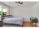 Bedroom with hardwood floors, ceiling fan, and natural light from the window at 3049 S Williams St, Denver, CO 80210