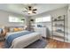 Comfortable bedroom featuring hardwood floors, ample natural light, and stylish decor at 3049 S Williams St, Denver, CO 80210