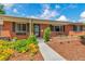 Charming brick home with a well-manicured front yard and beautiful landscaping at 3049 S Williams St, Denver, CO 80210