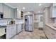 Kitchen with stainless refrigerator, tile backsplash, and modern gray cabinets at 3049 S Williams St, Denver, CO 80210