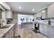 Open concept kitchen with stainless appliances and granite countertops with view to the dining room at 3049 S Williams St, Denver, CO 80210