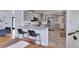 Eat-in kitchen features a granite counter bar with seating and view of the living room at 3049 S Williams St, Denver, CO 80210