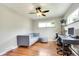 Bright living room featuring hardwood floors, a ceiling fan, and a stylish grey couch at 3049 S Williams St, Denver, CO 80210