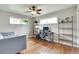 Bright living room offering hardwood floors, a modern ceiling fan, and stylish shelves at 3049 S Williams St, Denver, CO 80210