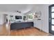 Bright living room with hardwood floors, a large window, and modern decor at 3049 S Williams St, Denver, CO 80210