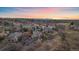Aerial view of a luxurious home in a beautiful neighborhood surrounded by lush trees at 1159 Buffalo Ridge Rd, Castle Pines, CO 80108