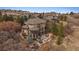 Aerial view of a stunning home with lush landscaping, and outdoor living spaces at 1159 Buffalo Ridge Rd, Castle Pines, CO 80108