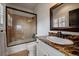 Bathroom with tile shower, granite countertop, and white cabinets providing ample storage at 1159 Buffalo Ridge Rd, Castle Pines, CO 80108
