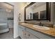 Bathroom featuring double sinks, granite counters and modern fixtures at 1159 Buffalo Ridge Rd, Castle Pines, CO 80108