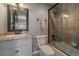 Elegant bathroom featuring a tub, glass shower, granite countertop, and decorative mirror at 1159 Buffalo Ridge Rd, Castle Pines, CO 80108