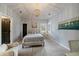 Bright bedroom featuring a decorative chandelier, comfortable seating, and natural light at 1159 Buffalo Ridge Rd, Castle Pines, CO 80108