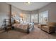 Comfortable bedroom with large windows, plush carpeting, and an accent chair at 1159 Buffalo Ridge Rd, Castle Pines, CO 80108