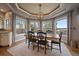 Elegant dining room with large windows providing natural light and views of the landscaped backyard at 1159 Buffalo Ridge Rd, Castle Pines, CO 80108