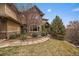 Beautiful front exterior with stone accents, manicured landscaping, and a welcoming walkway at 1159 Buffalo Ridge Rd, Castle Pines, CO 80108
