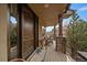 Welcoming front porch featuring a dark wood door, stone columns, and cozy seating with a decorative rug at 1159 Buffalo Ridge Rd, Castle Pines, CO 80108