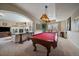 Spacious game room featuring a pool table, seating area, and elegant lighting fixtures at 1159 Buffalo Ridge Rd, Castle Pines, CO 80108