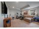 Home gym featuring workout machines, free weights, and a comfortable seating area at 1159 Buffalo Ridge Rd, Castle Pines, CO 80108