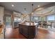 Open-concept kitchen and dining area with a large island, stainless steel appliances, and hardwood floors at 1159 Buffalo Ridge Rd, Castle Pines, CO 80108