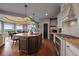 Modern kitchen with a large island, stainless steel appliances, and a view into the breakfast nook with a large bay window at 1159 Buffalo Ridge Rd, Castle Pines, CO 80108