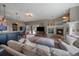 Open living area with stone fireplace, bar, and access to the outdoor patio at 1159 Buffalo Ridge Rd, Castle Pines, CO 80108