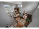 Open-concept living room with hardwood floors, fireplace, and large windows at 1159 Buffalo Ridge Rd, Castle Pines, CO 80108