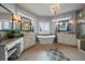 Luxurious main bathroom featuring dual vanities, a soaking tub, and a chandelier at 1159 Buffalo Ridge Rd, Castle Pines, CO 80108